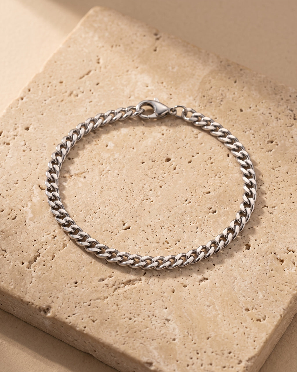 Silver Atlas 5 mm curb link bracelet closed on warm stone