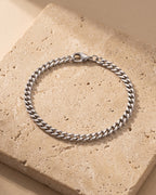 Silver Atlas 5 mm curb link bracelet closed on warm stone