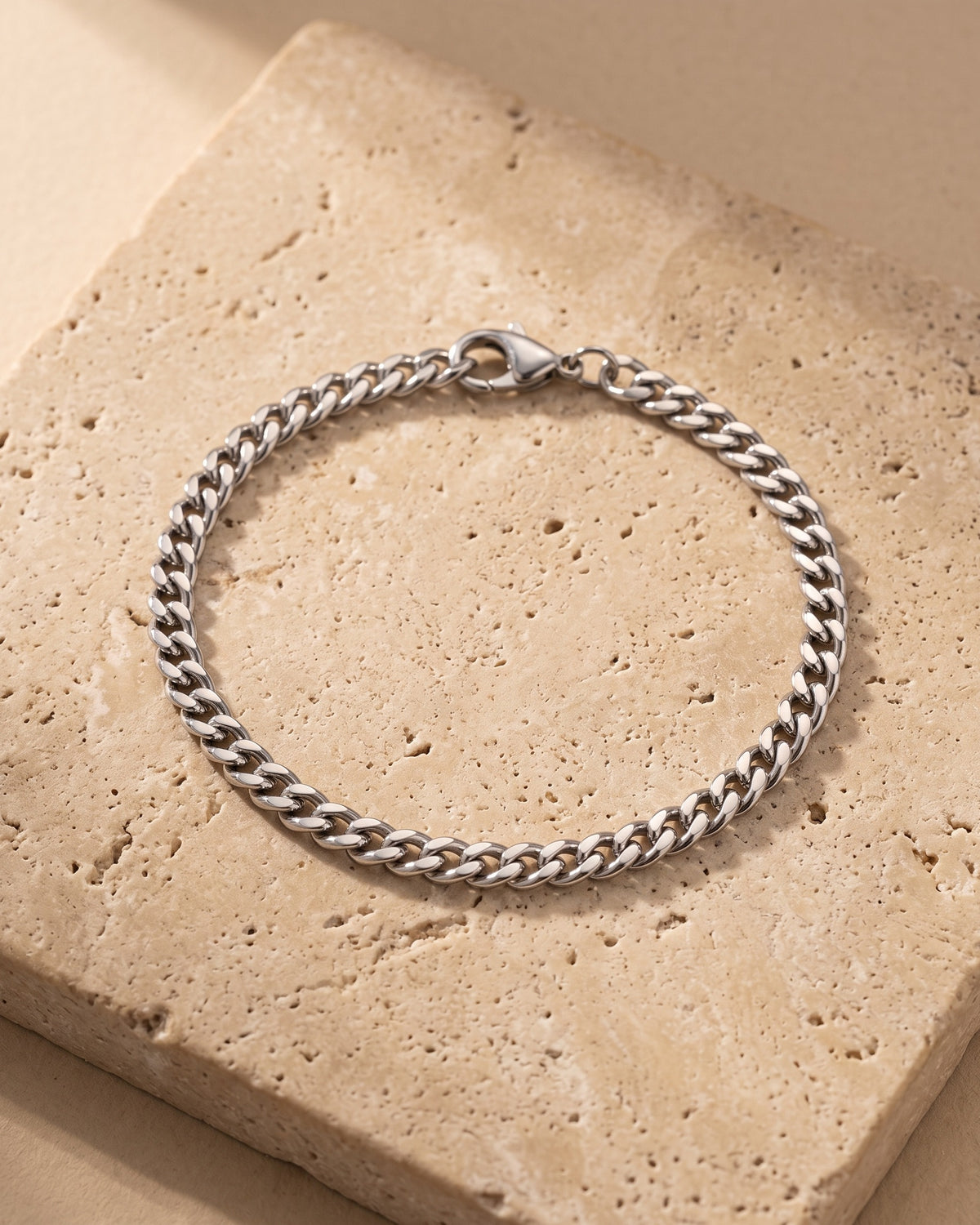 Silver Atlas 5 mm curb link bracelet closed on warm stone