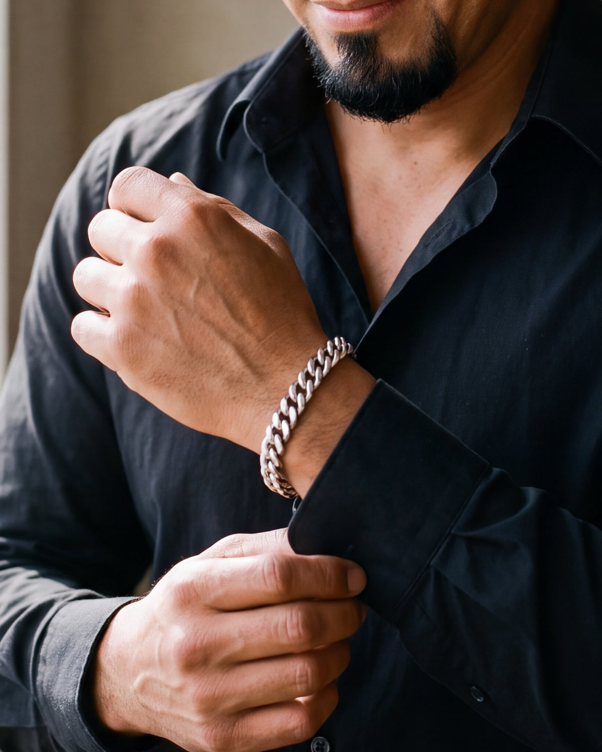 Close-up of the Atlas curb link bracelet in silver-tone steel, worn at true size