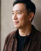 Man in a brown suede overshirt in profile, wearing the 12 mm silver Atlas cubic zirconia hoop earring