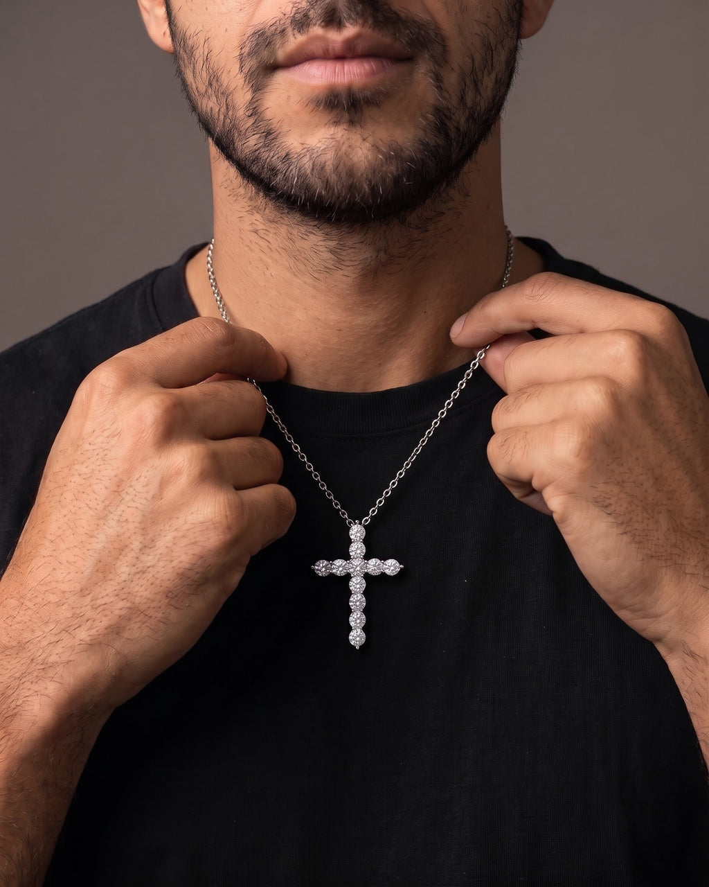 Hand lifting the Atlas CZ Cross Necklace in Titanium Steel at the collarbone