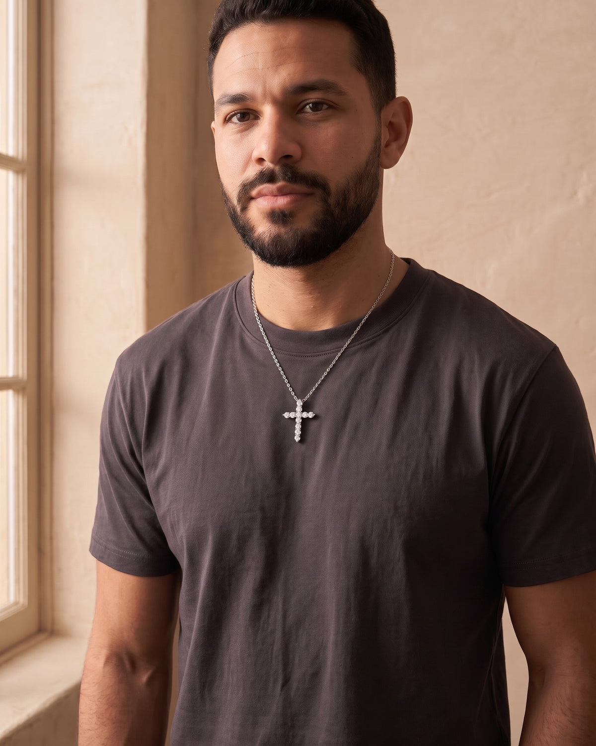 Man wearing the silver Atlas CZ Cross Necklace in Titanium Steel