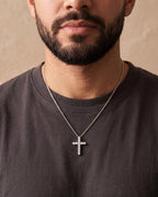 Close-up of the silver Atlas CZ Cross Necklace in Titanium Steel worn by a man, shown at true size