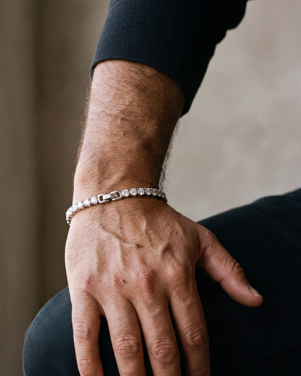 Close-up of the silver Atlas CZ tennis bracelet on a man's wrist at true size, with its box clasp