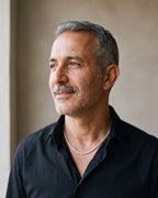 Man in a black shirt by a window wearing the silver Atlas CZ tennis chain