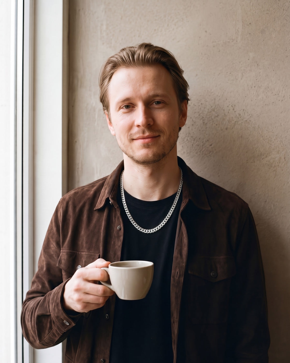 Man wearing the silver Atlas Dense Cuban Link Chain in Silver-Tone Steel