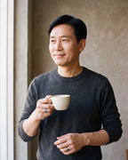 Man in a navy knit polo wearing the Atlas diagonal cut geometric ring in blue