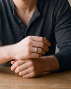 Close-up of the Atlas diagonal cut geometric ring in silver-tone steel, worn at true size