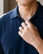 Close-up of the Atlas diamond cut faceted ring in gold-tone steel, worn at true size