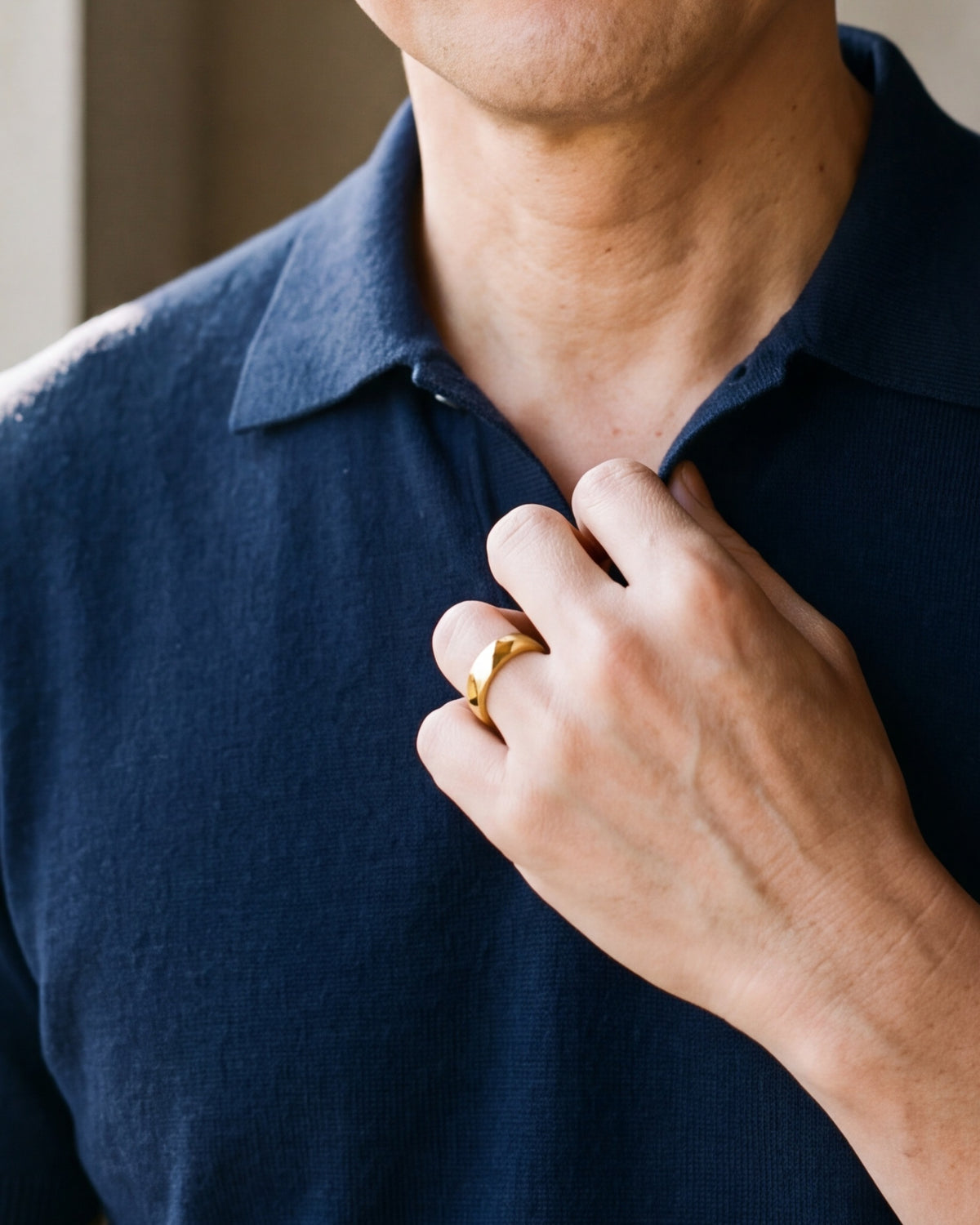 Close-up of the Atlas diamond cut faceted ring in gold-tone steel, worn at true size