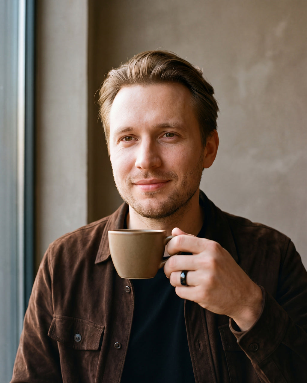 Man in a brown suede overshirt over a black t-shirt wearing the Atlas domed band in black steel