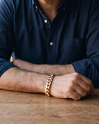 Close-up of the Atlas double-latch Cuban bracelet in gold-tone steel, worn at true size