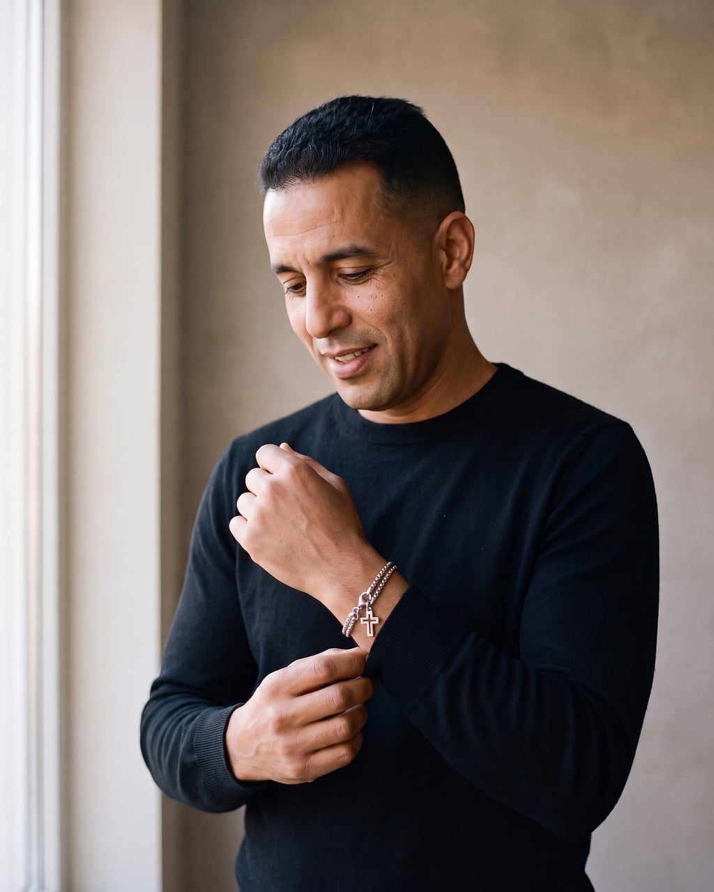 Man wearing the silver Atlas Double Rolo Chain Cross Bracelet