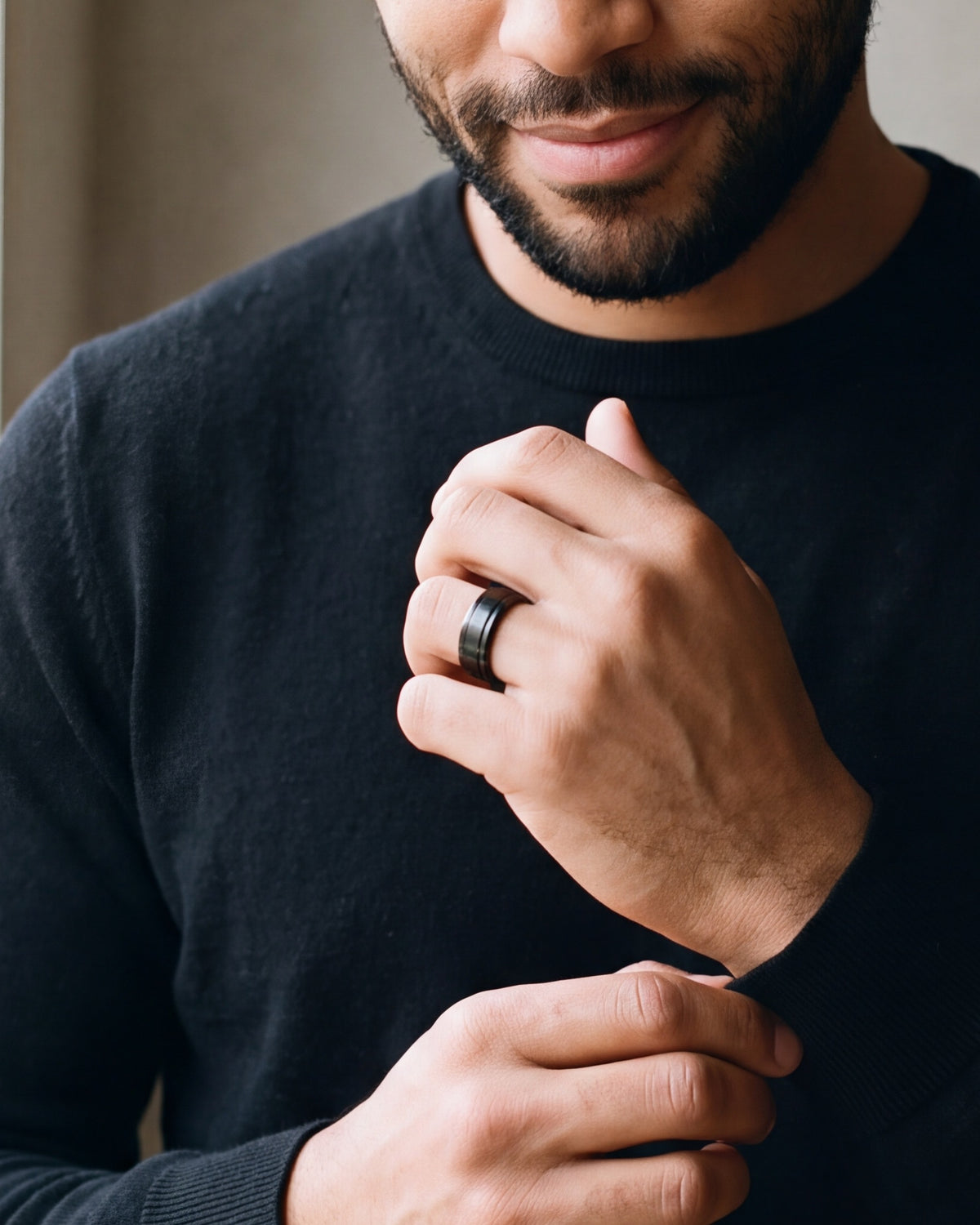 Close-up of the Atlas dual groove ring in black steel, worn at true size