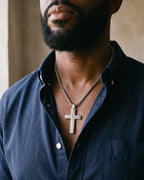 Atlas Our Father engraved cross pendant necklace in silver-tone titanium steel worn on the chest, close-up