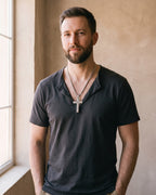 Man wearing the silver Atlas Engraved Cross Necklace in Titanium Steel