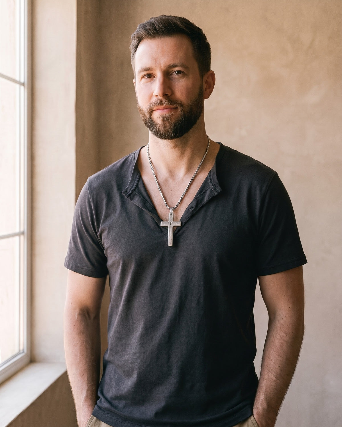 Man wearing the silver Atlas Engraved Cross Necklace in Titanium Steel