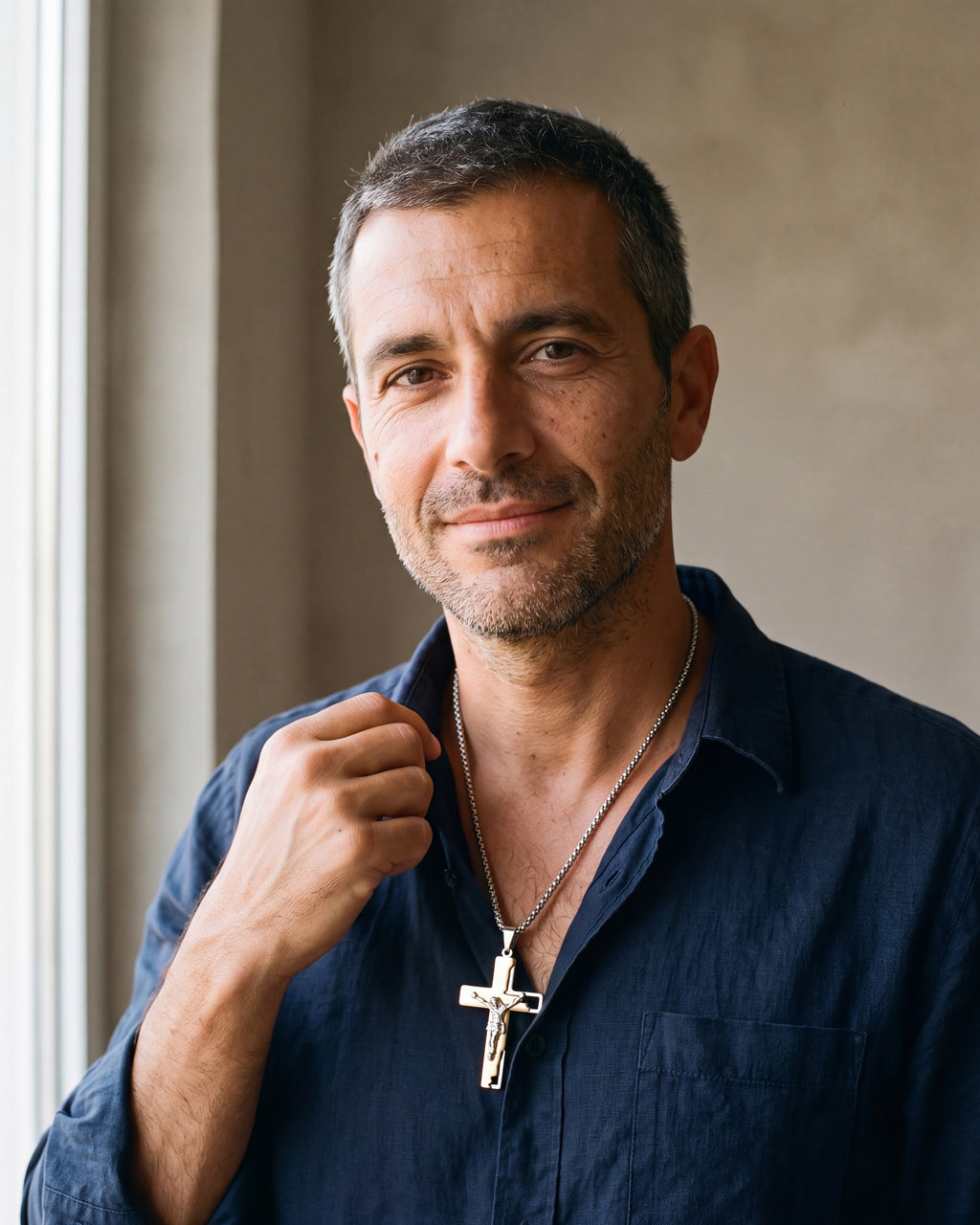 Second man in a dark navy linen shirt wearing the gold-tone Atlas engraved crucifix pendant necklace