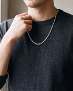 Close-up of the 4 mm silver Atlas rope chain on a man's neck at true size