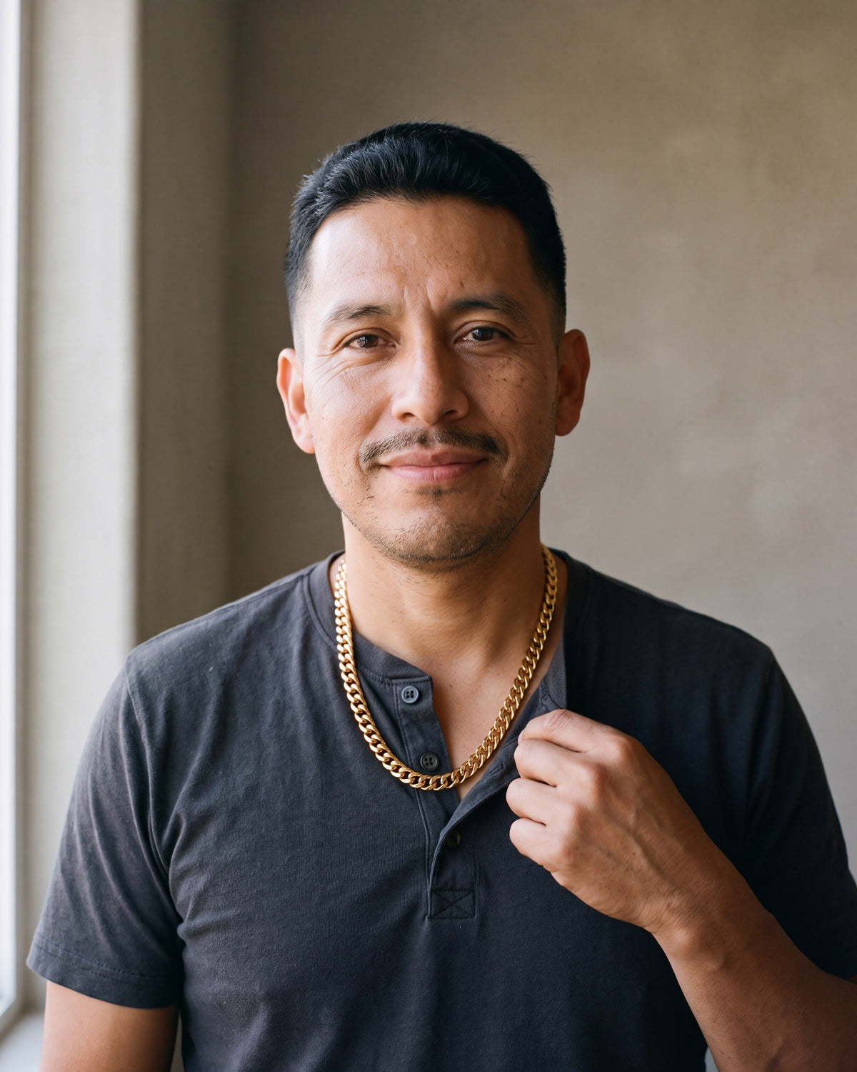 Second man in a charcoal cotton henley t-shirt wearing the gold-tone Atlas faceted double-link cuban chain