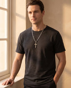 Man wearing the silver Atlas Figaro Chain Cross Necklace in Titanium Steel