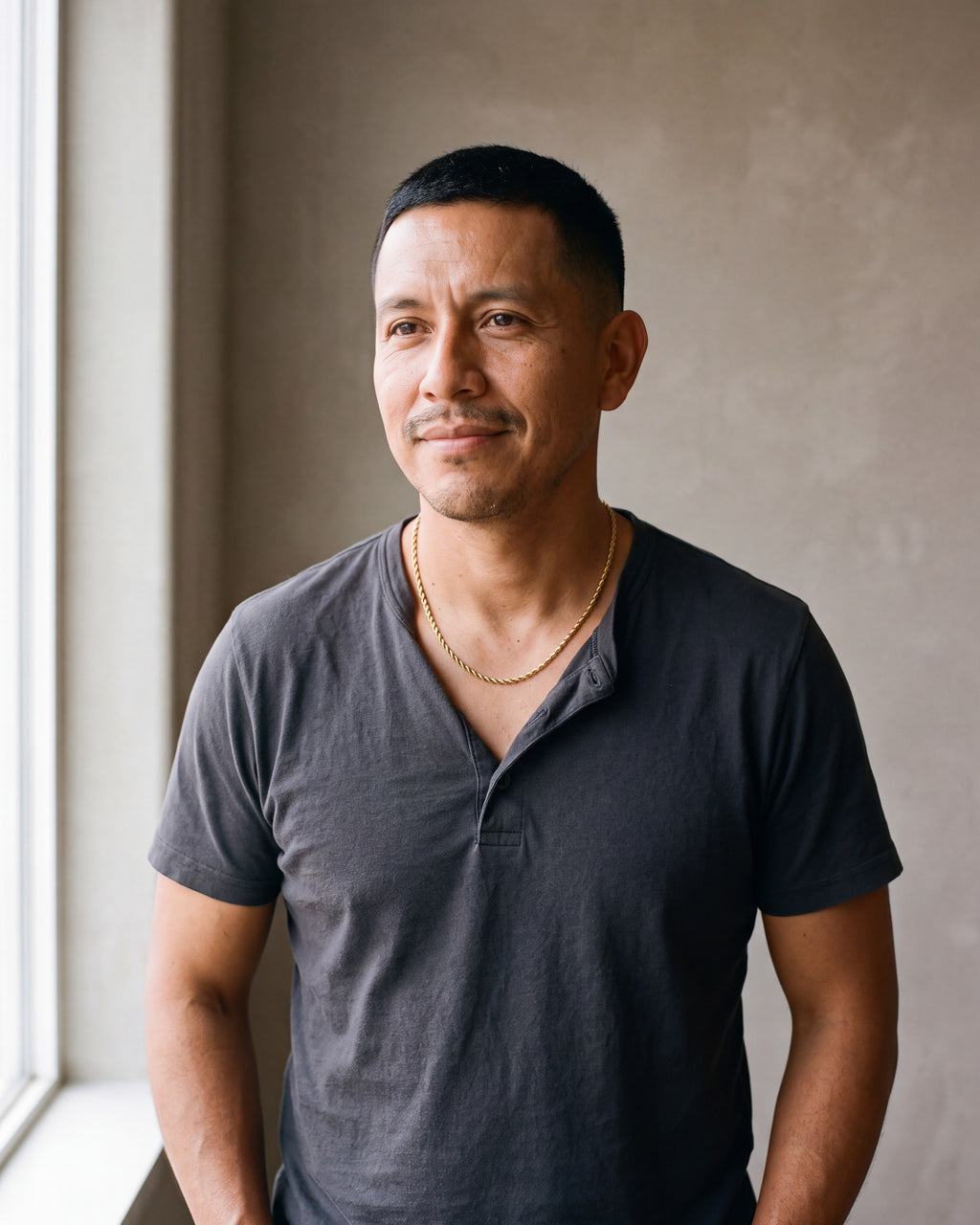 Second man in a charcoal cotton henley t-shirt wearing the gold-tone Atlas fine rope chain
