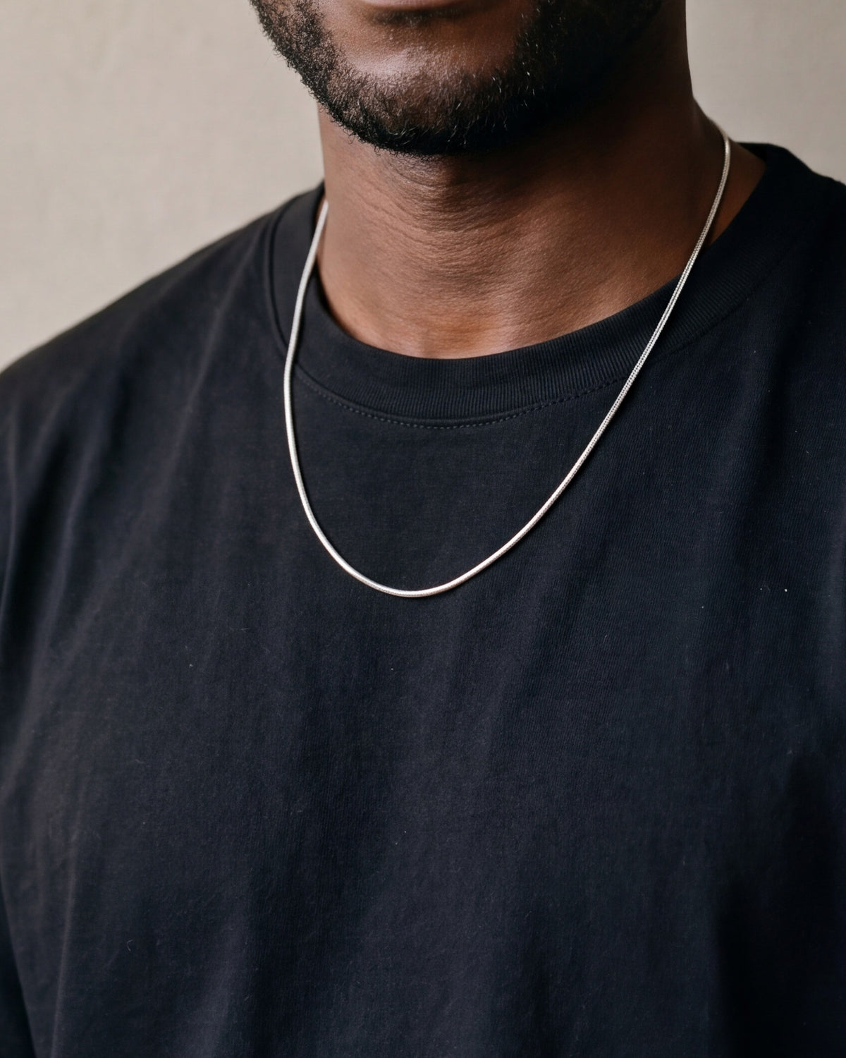 Close-up of the silver-tone Atlas Fine Snake Chain worn at true size
