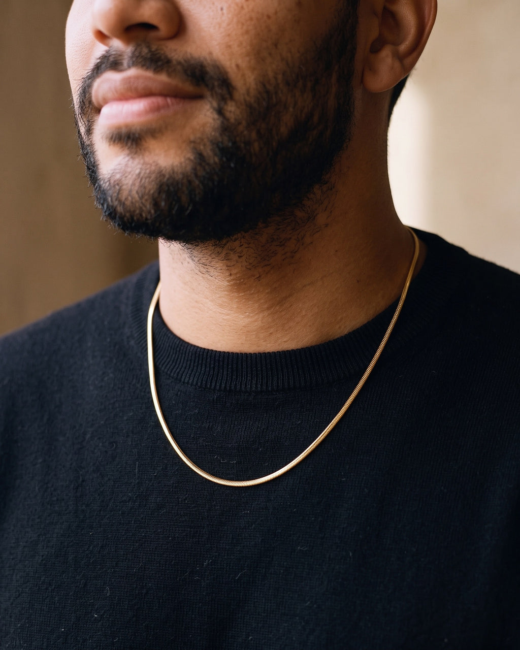 Close-up of the Atlas fine 1.8 mm snake chain in gold-tone stainless steel worn at true size