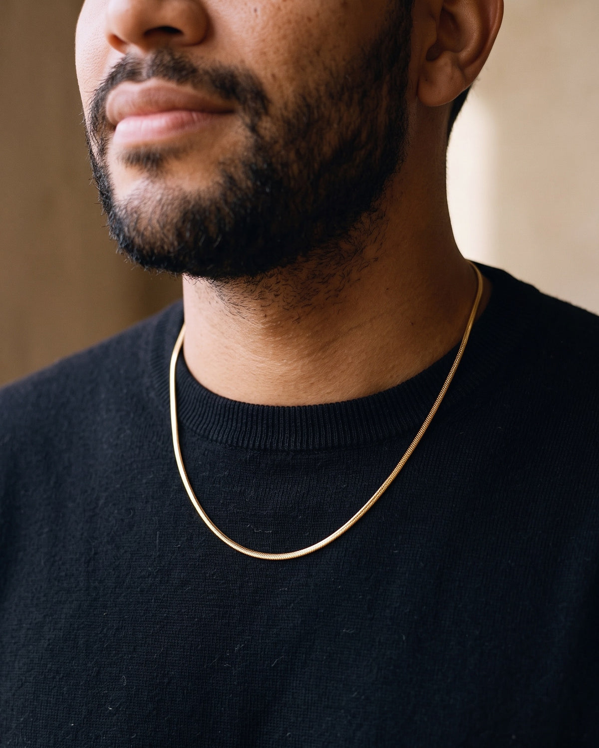 Close-up of the Atlas fine 1.8 mm snake chain in gold-tone stainless steel worn at true size