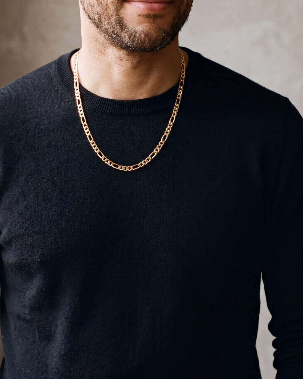Close-up of the gold-tone Atlas Flat Gold-Tone Figaro Chain worn at true size
