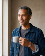 Man in a denim jacket holding a coffee cup, wearing the silver-tone Atlas geometric link cuff