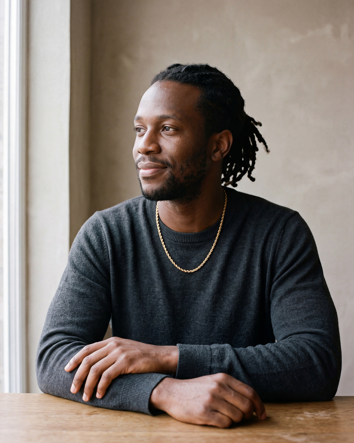 Second man in a charcoal fine-gauge knit crew-neck sweater wearing the gold-tone Atlas gold-tone rope chain