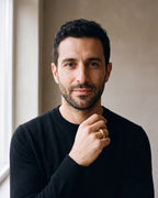 Man in a black merino crew-neck sweater wearing the gold-tone Atlas Gold-Tone Tapered Dome Ring