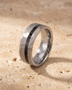 The whole silver-tone Atlas Hammered Inlay Ring lying on warm travertine stone