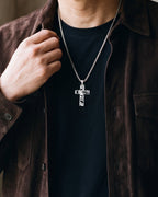 Close-up of the silver-tone Atlas hollow cut-out cross pendant necklace worn, true size