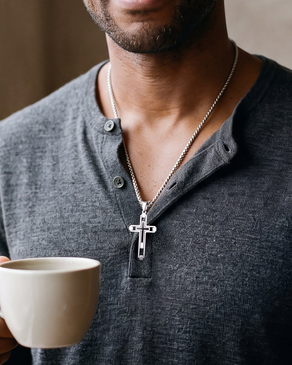 Close-up of the silver-tone Atlas hollow geometric cross pendant necklace worn, true size