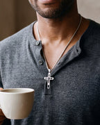 Close-up of the silver-tone Atlas hollow geometric cross pendant necklace worn, true size