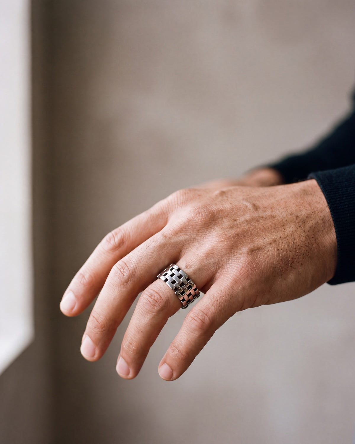 Close-up of the silver-tone Atlas Hollow Link Ring worn at true size