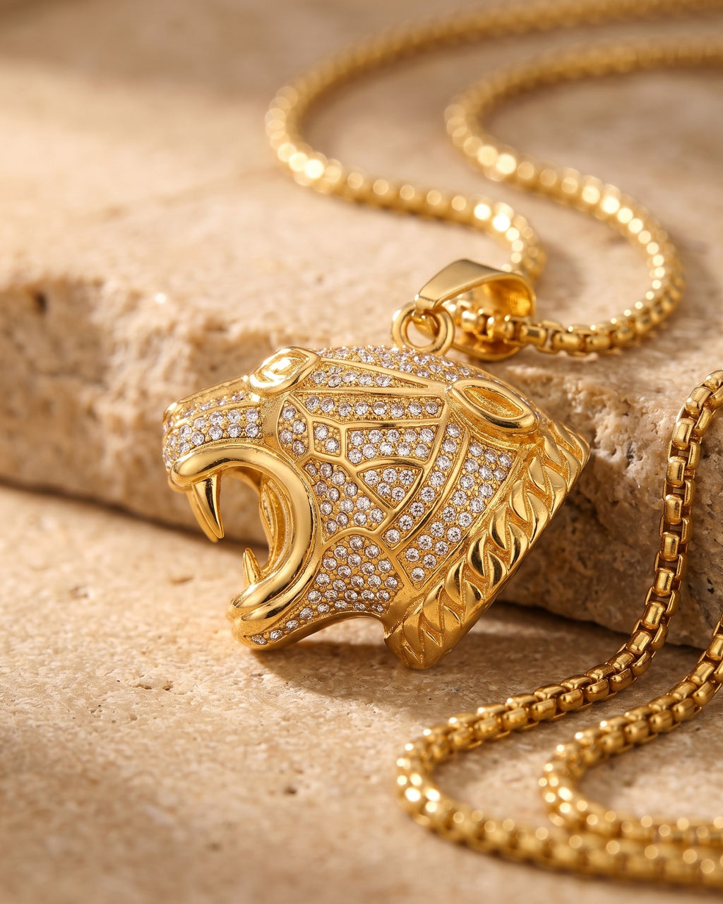 Close-up of the gold-tone Atlas iced leopard pendant necklace worn by a man, shown at true size