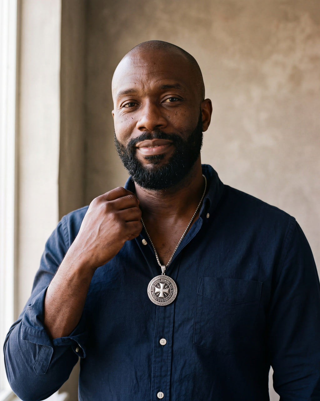 Man in a navy shirt wearing the silver-tone Atlas Knights Templar cross medallion necklace with Greek key border