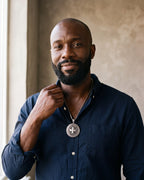 Man in a navy shirt wearing the silver-tone Atlas Knights Templar cross medallion necklace with Greek key border