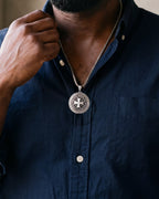 Close-up of the silver-tone Atlas Knights Templar cross medallion necklace worn, true size