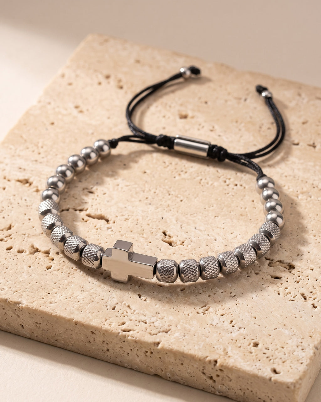 The silver-tone Atlas knurled cross bead bracelet on warm stone
