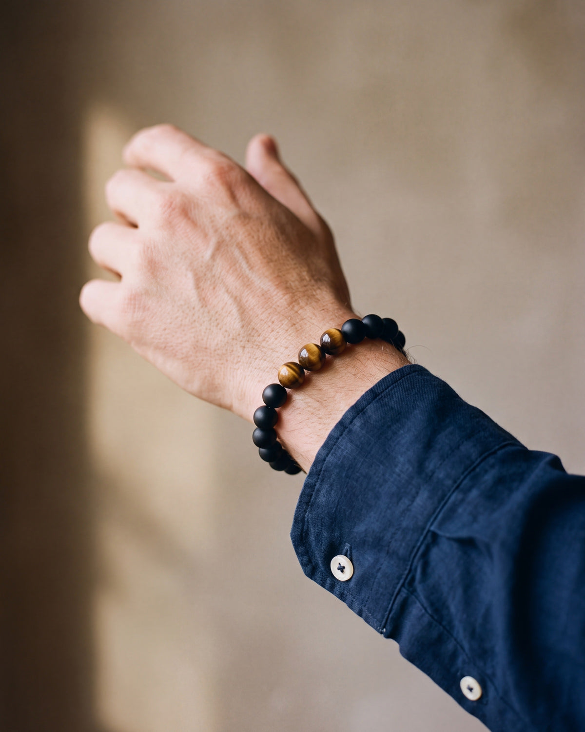 Close-up of the Black & Tiger Eye Atlas Lava and Tiger Eye Stone Bead Bracelet worn at true size