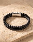 Atlas leather and lava stone double bracelet on warm stone