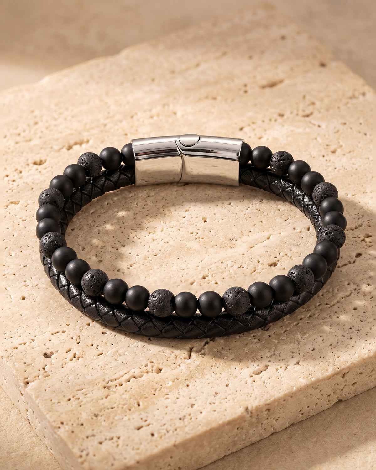 Atlas leather and lava stone double bracelet on warm stone