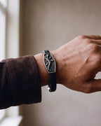 Close-up of the Atlas lizard plaque bracelet on a man's wrist