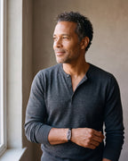 Man in a charcoal henley by a window wearing the Atlas lizard plaque leather bracelet