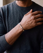 Close-up of the silver-tone Atlas mobius twist cuff bracelet worn at true size